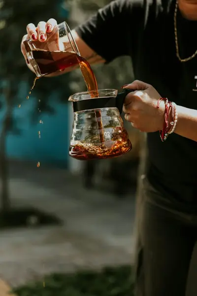 Barista carefully pouring coffee into a cup, demonstrating the craft of Irish coffee making