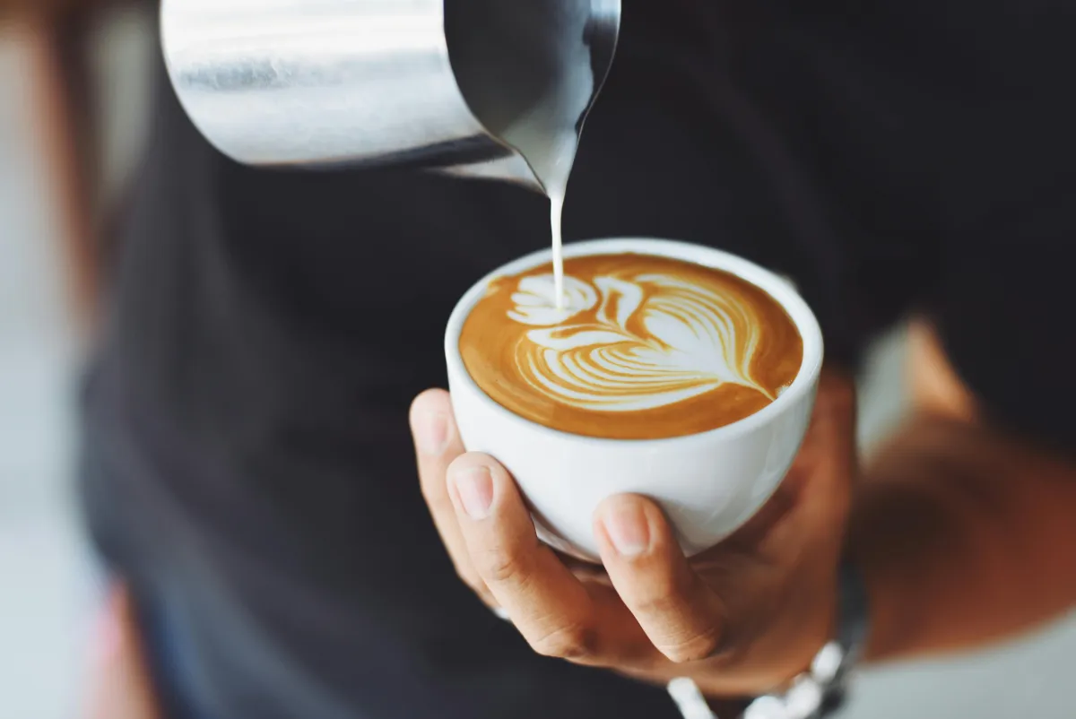 Barista pouring coffee at a local cafe in Ireland